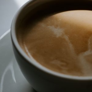 white ceramic cup with brown liquid
