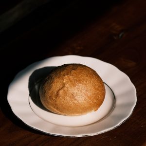 a white plate topped with a loaf of bread